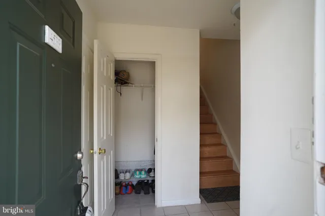 a view of a hallway with an entryway and stairs