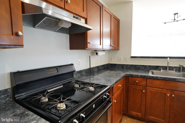 a kitchen with a stove and a sink
