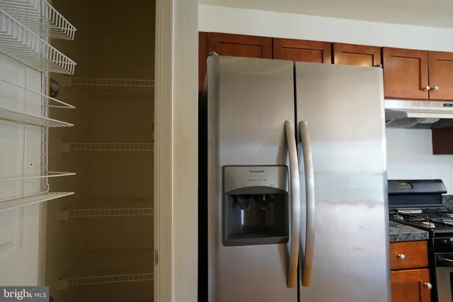 a metallic refrigerator freezer sitting in a kitchen