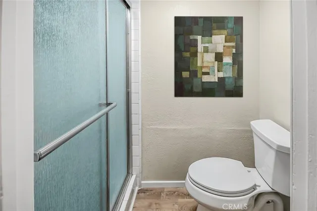 a white toilet sitting next to a bathroom sink