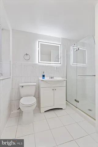 a bathroom with a toilet sink and a shower