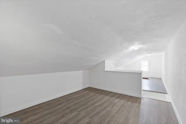 a view of an empty room and wooden floor