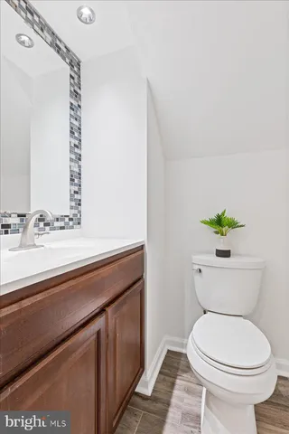 a bathroom with a toilet a sink and a mirror