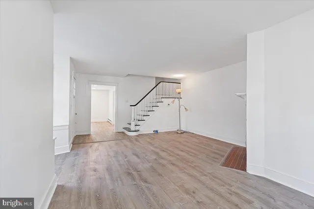 a view of an empty room with stairs and ventilation