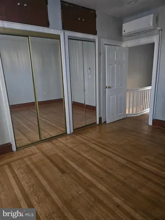 a view of room with window and wooden floor