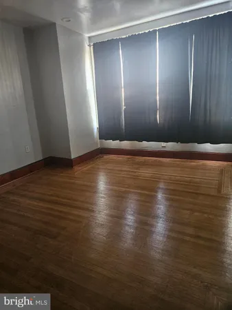 a view of room with wooden floor