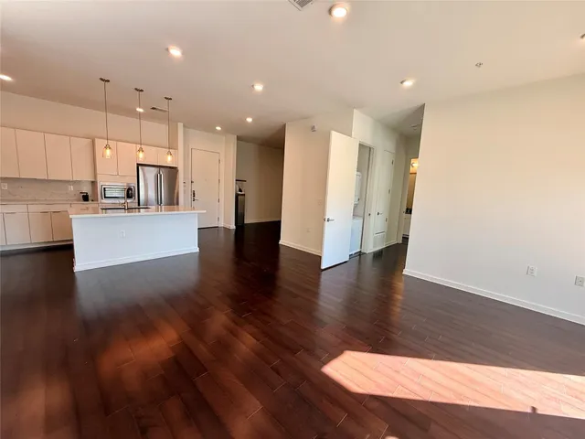 a kitchen with kitchen island a stove a sink a refrigerator and chairs