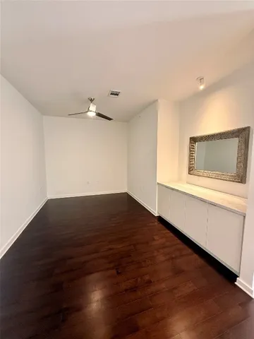 a kitchen with counter top space a sink and living room view