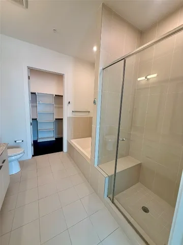 a bathroom with a shower and a toilet