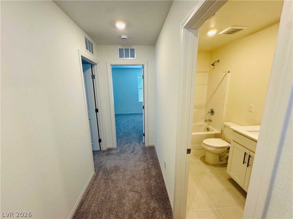 9249 Innot Avenue Las Vegas, NV 89148 - Photo 11 of 24 Hallway leading to a full bath and additional rooms, ready for personalization.