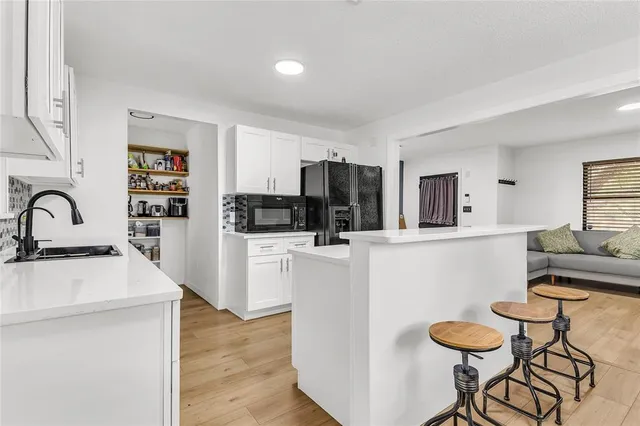 a kitchen with a refrigerator and a stove top oven