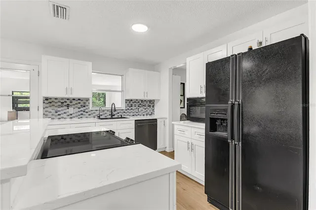 a kitchen with a stove and a window
