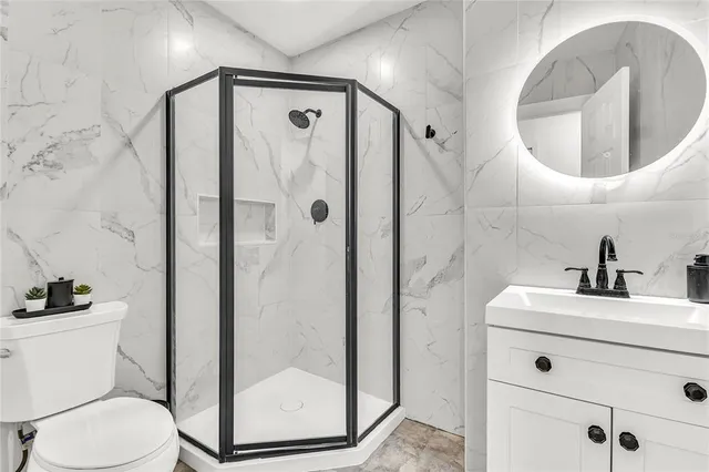 a view of a bedroom with wooden floor and shoes