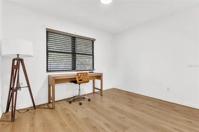 a bedroom with a bed and a chair