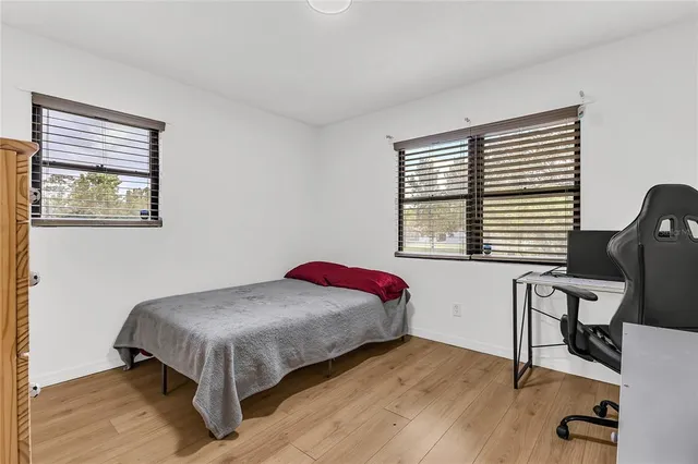 a bedroom with a bed and a night stand