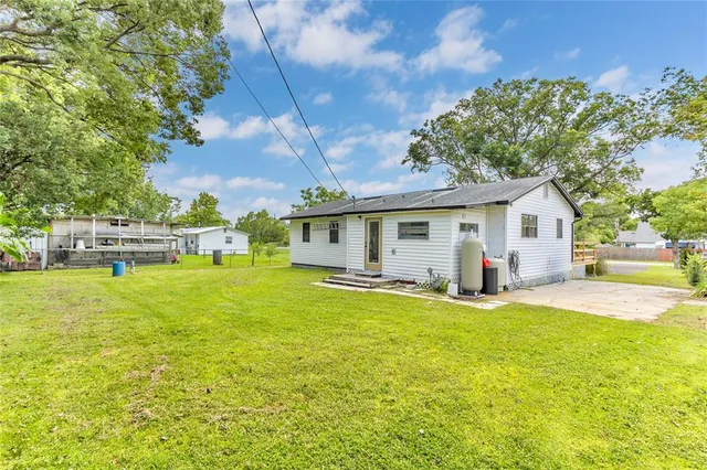 a view of a house with a yard and sitting area