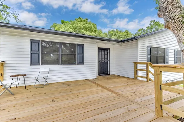 a view of a backyard with sitting area