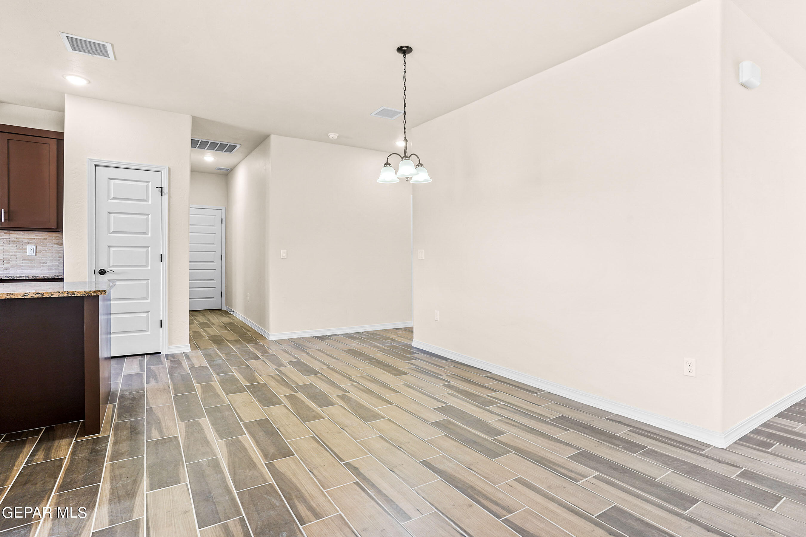 871 Country Club Road, Unit 4E El Paso, TX 79932 - Photo 11 of 34 a view of a room with wooden floor