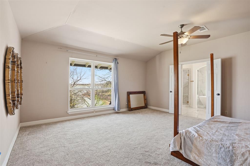 13280 Beach Club Road The Colony, TX 75056 - Photo 18 of 40 a spacious bedroom with a bed and a window