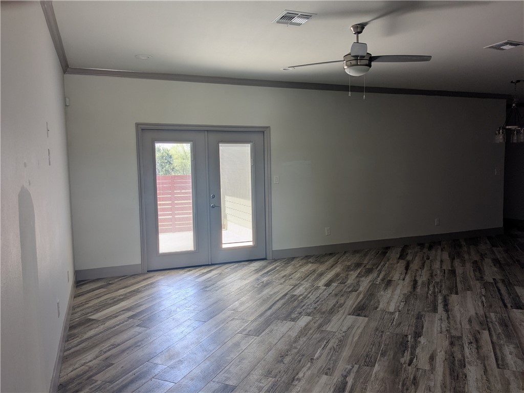 5375 County Road 73A, Unit C55 Robstown, TX 78380 - Photo 2 of 10 a view of an empty room with a window and wooden floor