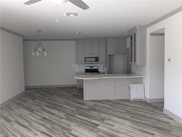 a kitchen with a refrigerator and a stove top oven