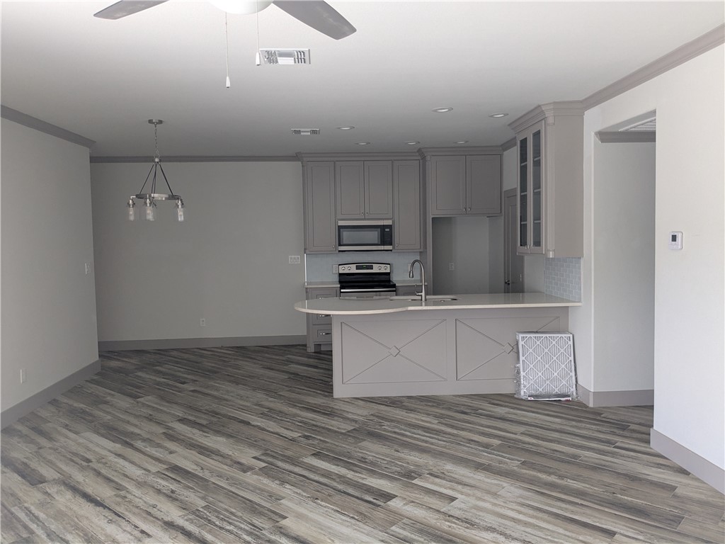 5375 County Road 73A, Unit C55 Robstown, TX 78380 - Photo 4 of 10 a kitchen with a refrigerator and a stove top oven