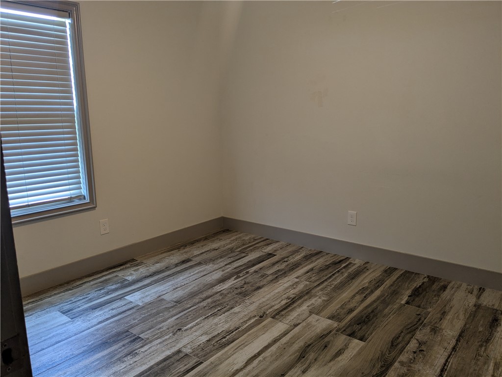 5375 County Road 73A, Unit C55 Robstown, TX 78380 - Photo 8 of 10 a view of a room with wooden floor and a window