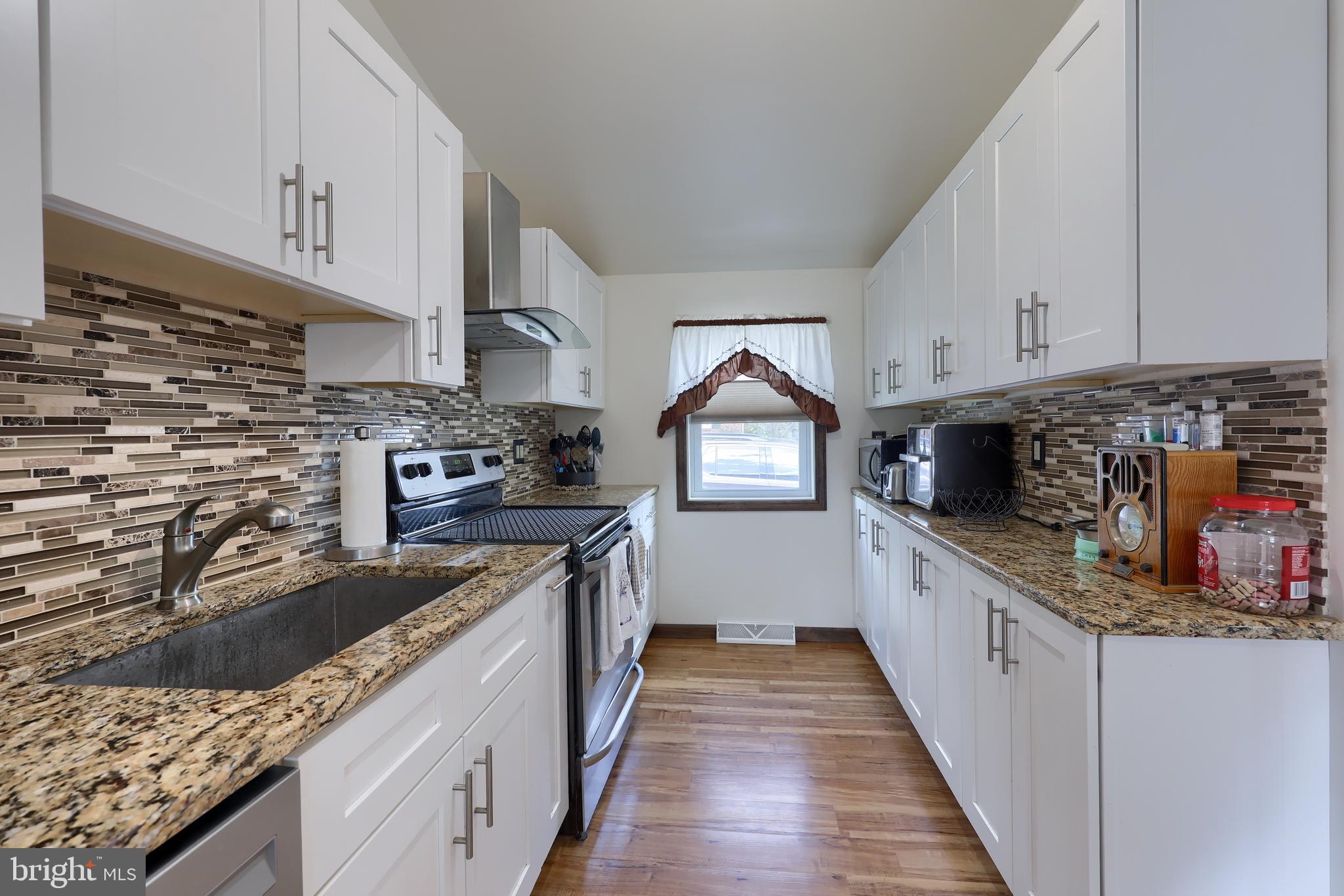 264 Noble Street Lititz, PA 17543 - Photo 11 of 28 a kitchen with stainless steel appliances granite countertop a stove sink and cabinets