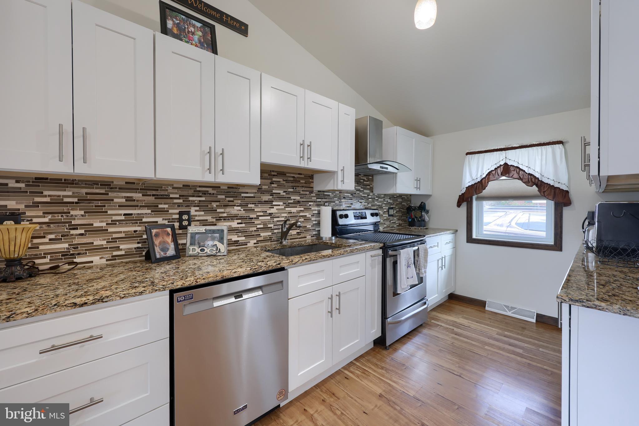 264 Noble Street Lititz, PA 17543 - Photo 12 of 28 a kitchen with granite countertop a sink a stove and cabinets