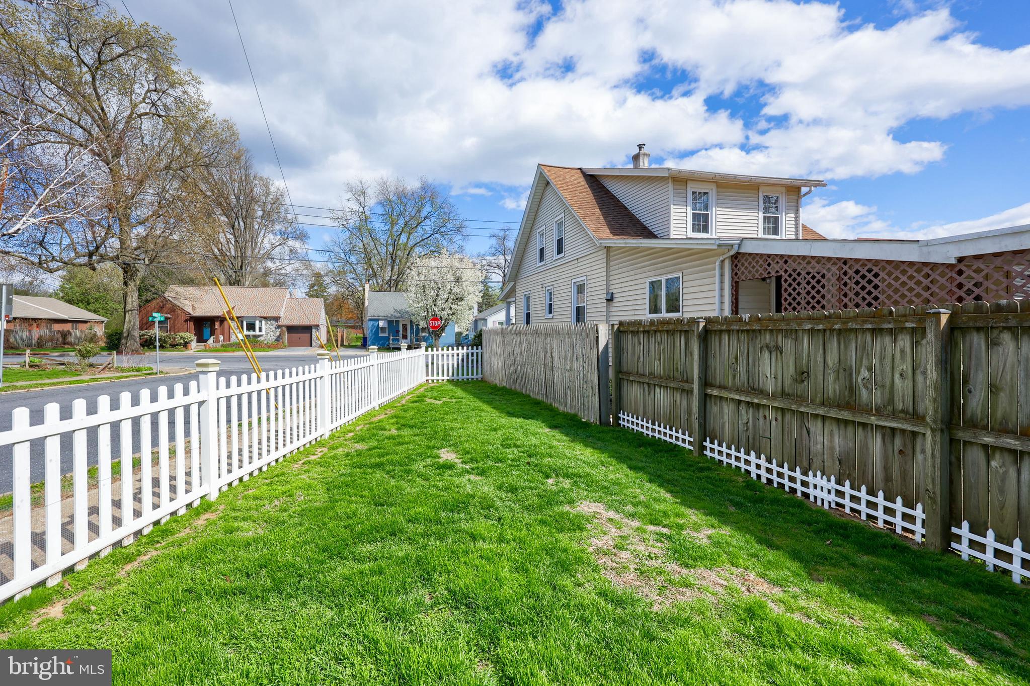 264 Noble Street Lititz, PA 17543 - Photo 22 of 28 a view of a house with wooden fence next to a yard