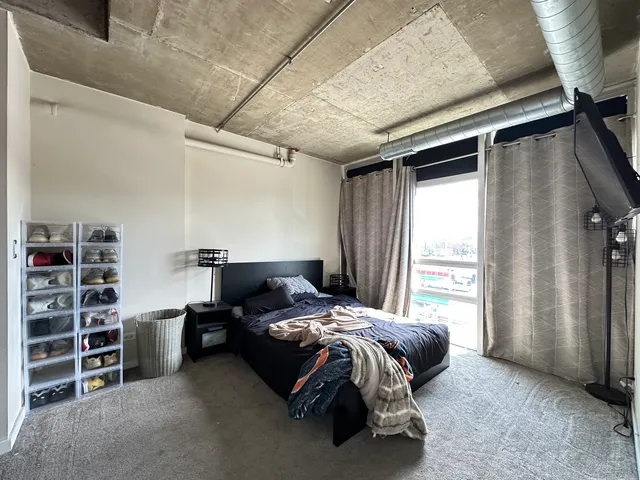 a bedroom with a bed and a window