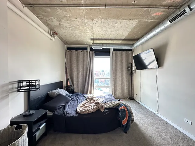 a bed room with bed and window