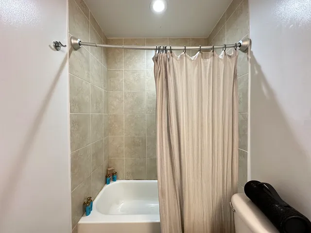 a bathroom with a shower curtain and a window