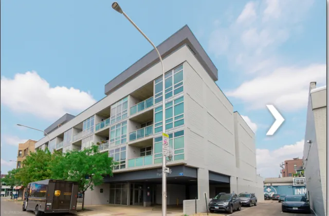 a view of building with car parked