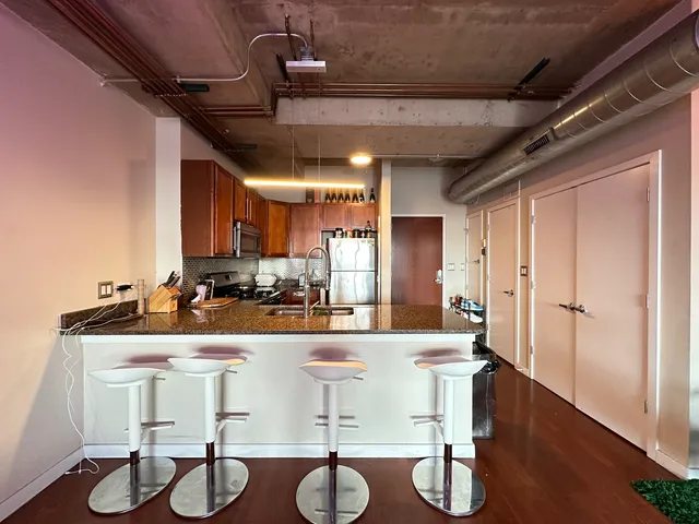 a kitchen with a table chairs and a chandelier