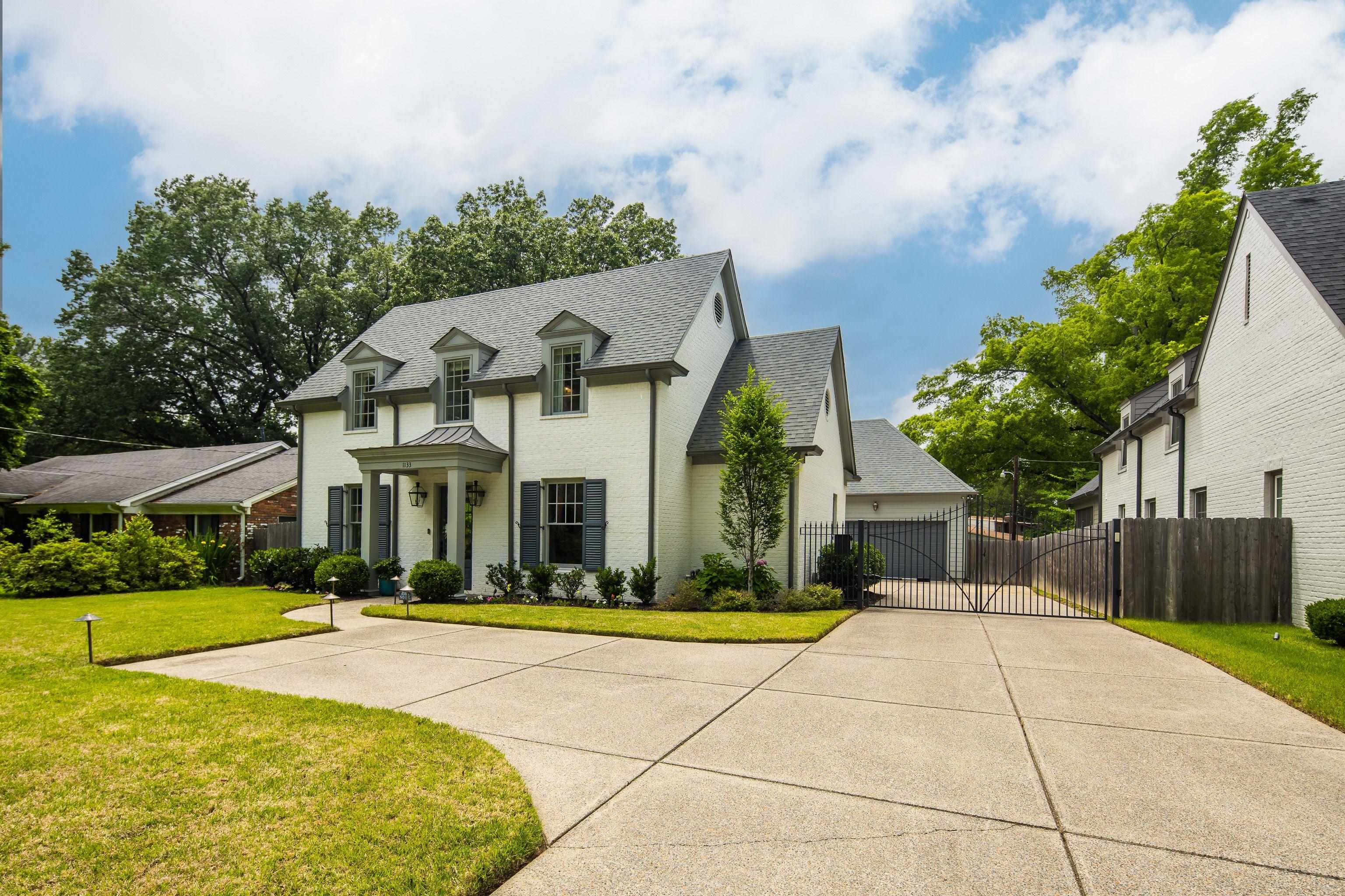 1133 Hayne Road Memphis, TN 38119 - Photo 1 of 34 French country home with a shingled roof, a gate, brick siding, and a garage