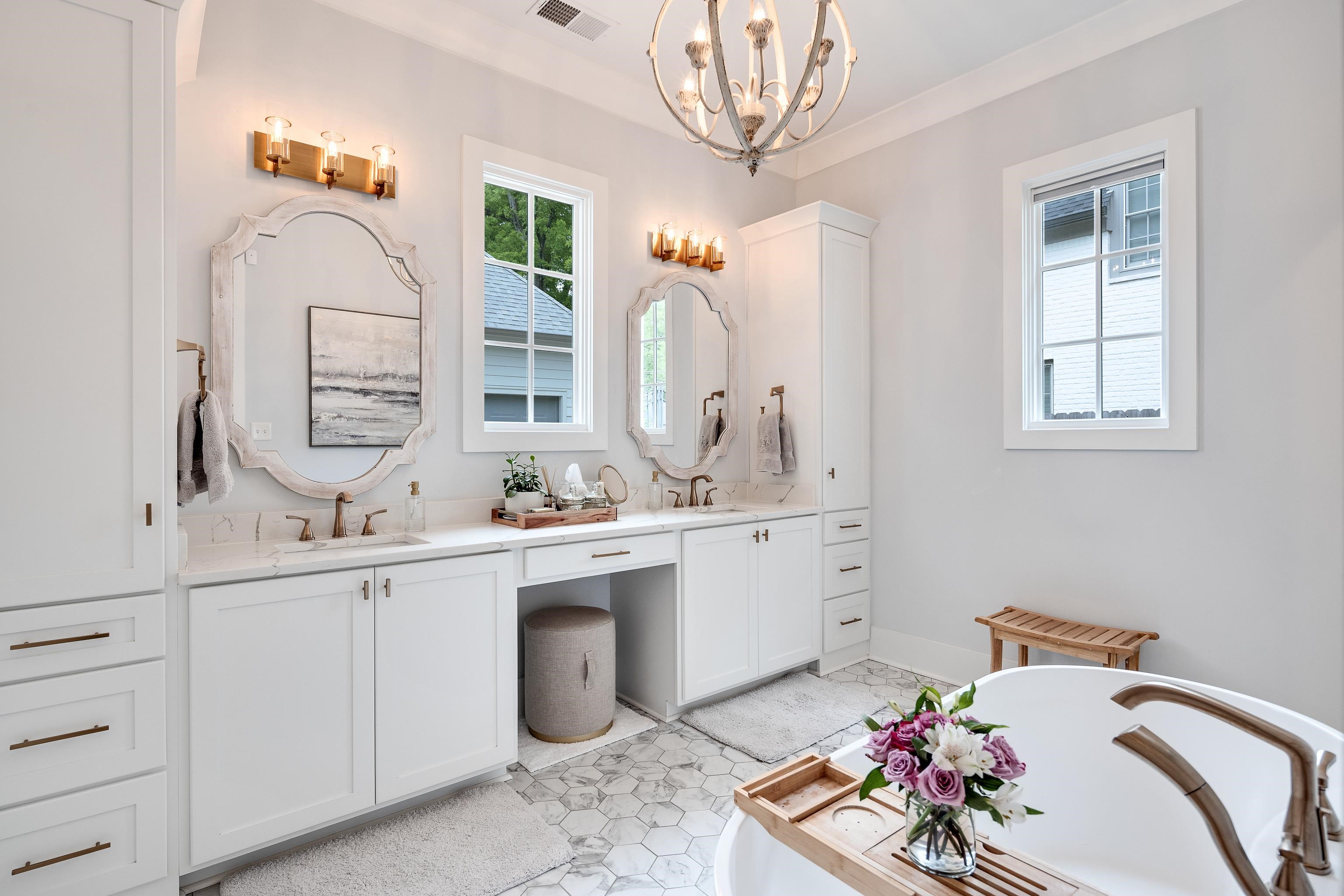 1133 Hayne Road Memphis, TN 38119 - Photo 20 of 34 Full bath with a chandelier, double vanity, and a soaking tub