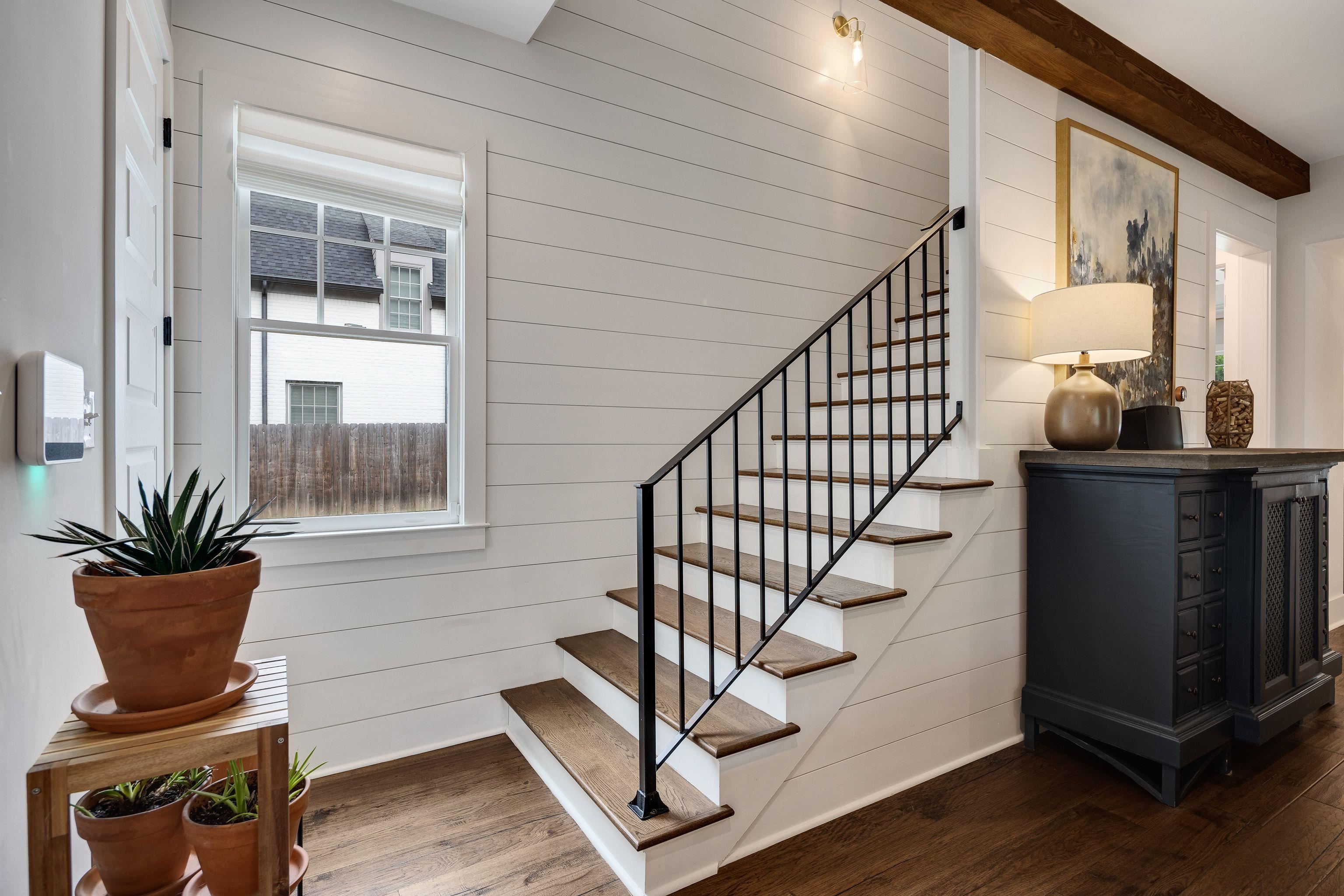 1133 Hayne Road Memphis, TN 38119 - Photo 23 of 34 Staircase featuring wood finished floors, wood walls, and beamed ceiling