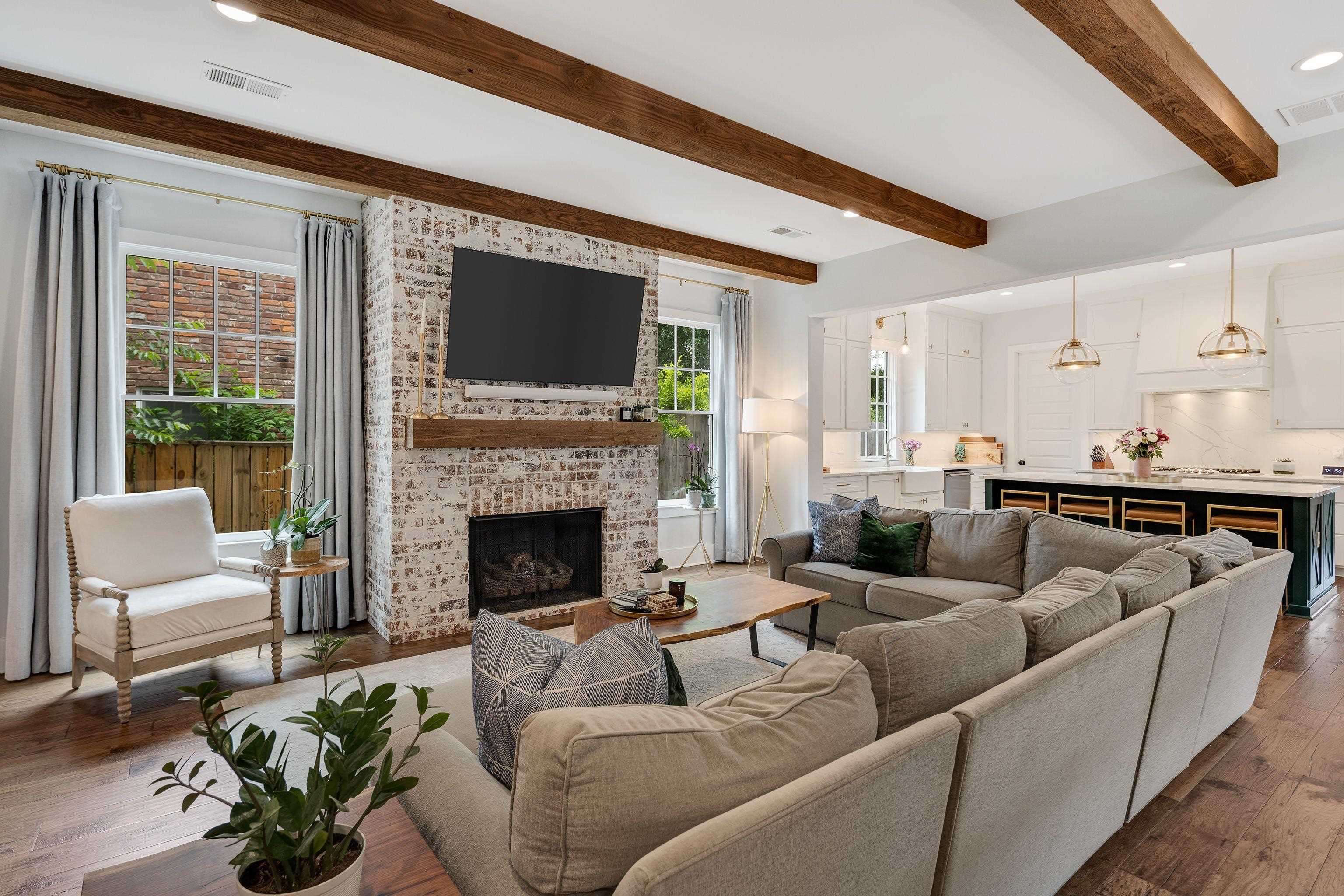 1133 Hayne Road Memphis, TN 38119 - Photo 7 of 34 Living room with beam ceiling, a brick fireplace, dark wood-style flooring, and recessed lighting