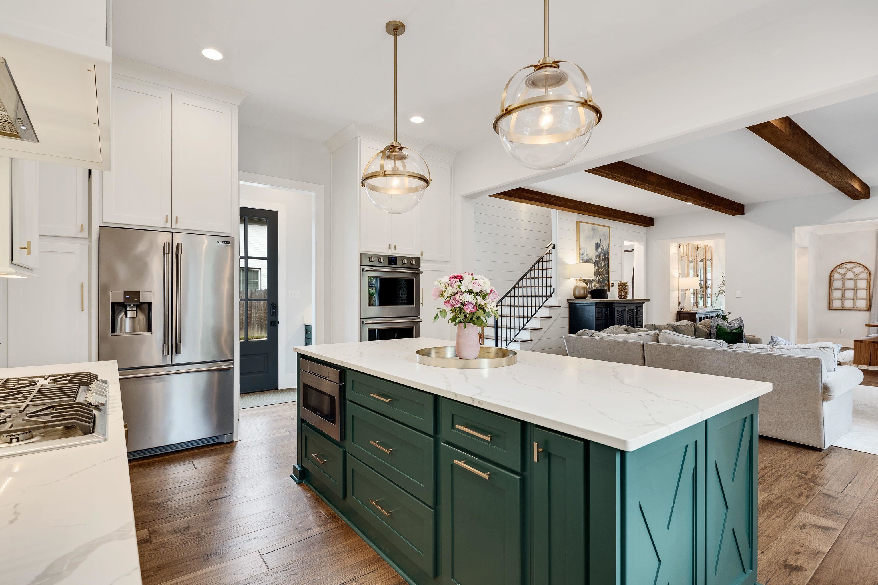 1133 Hayne Road Memphis, TN 38119 - Photo 10 of 34 Kitchen with stainless steel appliances, green cabinetry, white cabinets, light wood-style flooring, and beamed ceiling