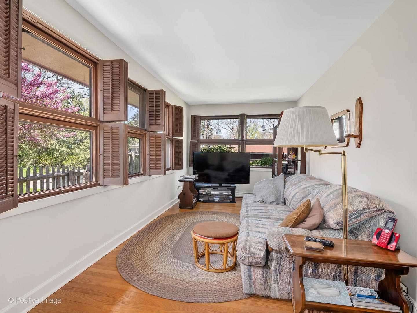 516 Eldon Place Downers Grove, IL 60516 - Photo 16 of 18 a living room with furniture a flat screen tv and a floor to ceiling window