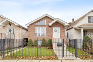 2929 North Rutherford Avenue Chicago, IL 60634 - Photo 1 of 26 a view of a brick house with large windows and a table and chairs