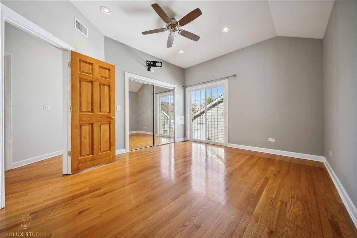 2929 North Rutherford Avenue Chicago, IL 60634 - Photo 19 of 26 a view of an empty room with window and wooden floor