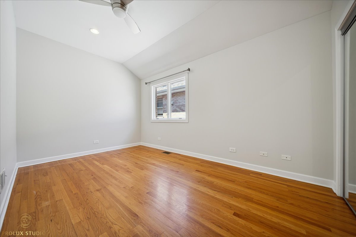 2929 North Rutherford Avenue Chicago, IL 60634 - Photo 20 of 26 a view of an empty room with wooden floor and a window