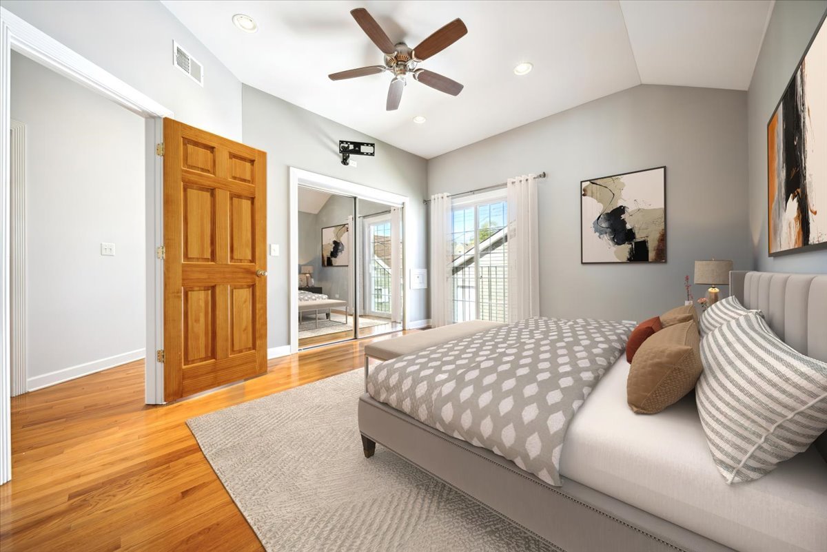 2929 North Rutherford Avenue Chicago, IL 60634 - Photo 3 of 26 a bedroom with a large bed chandelier and a window