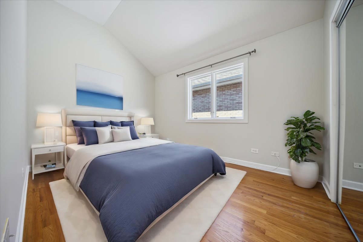 2929 North Rutherford Avenue Chicago, IL 60634 - Photo 5 of 26 a bedroom with bed and potted plant