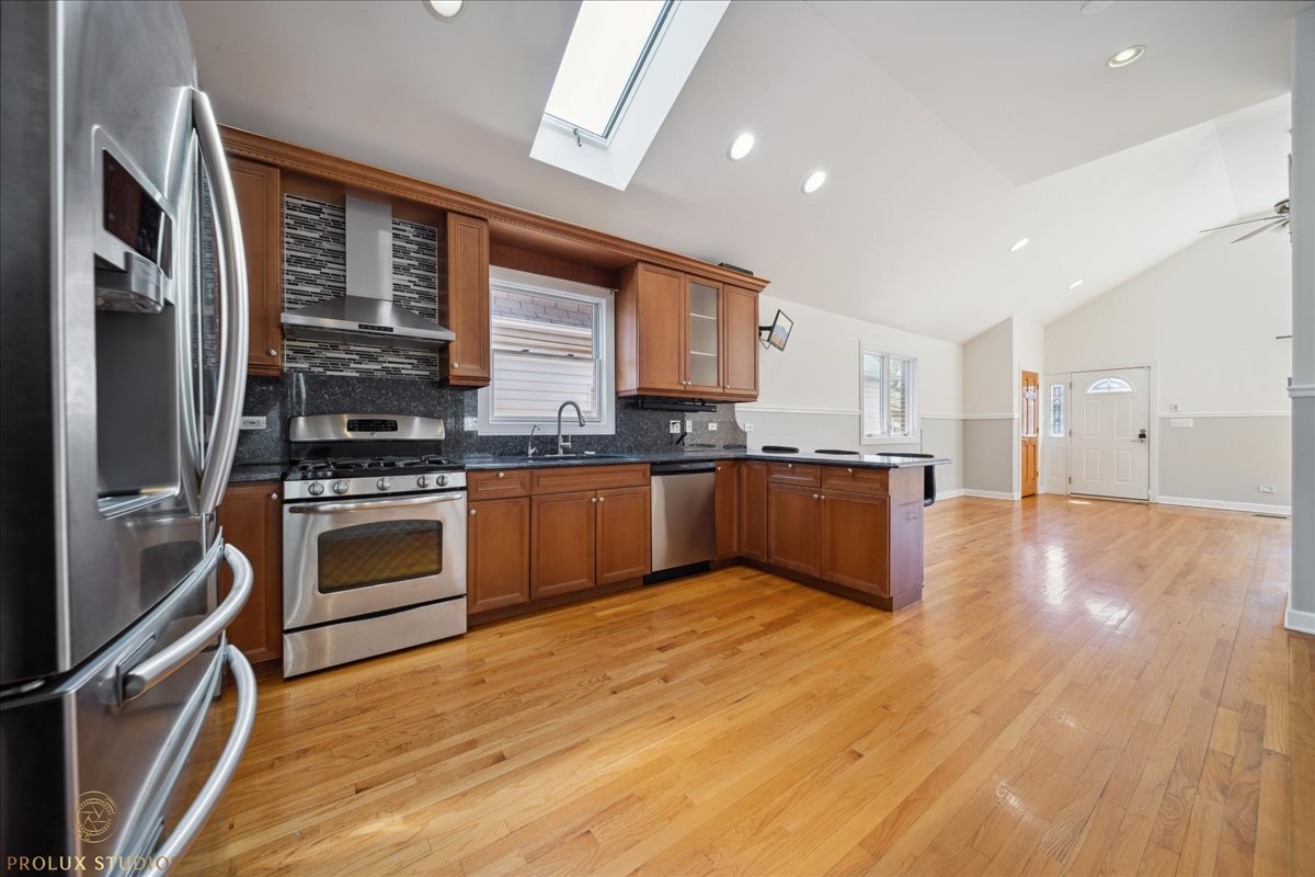 2929 North Rutherford Avenue Chicago, IL 60634 - Photo 7 of 26 a kitchen with stainless steel appliances granite countertop a stove top oven and sink
