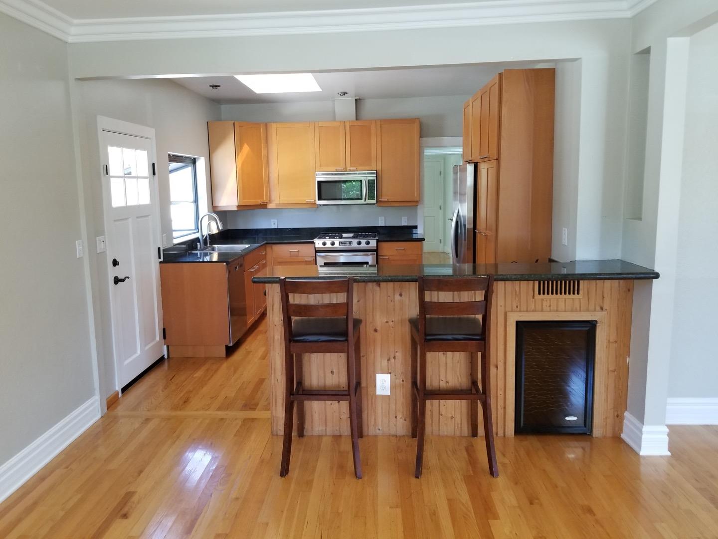 537 View Street Mountain View, CA 94041 - Photo 2 of 9 a kitchen with stainless steel appliances a stove a refrigerator and a fireplace