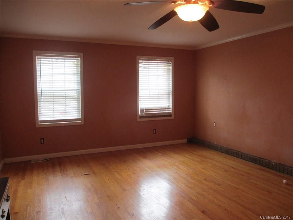 2312 Sunshine Road Lancaster, SC 29720 - Photo 11 of 16 an empty room with wooden floor and windows