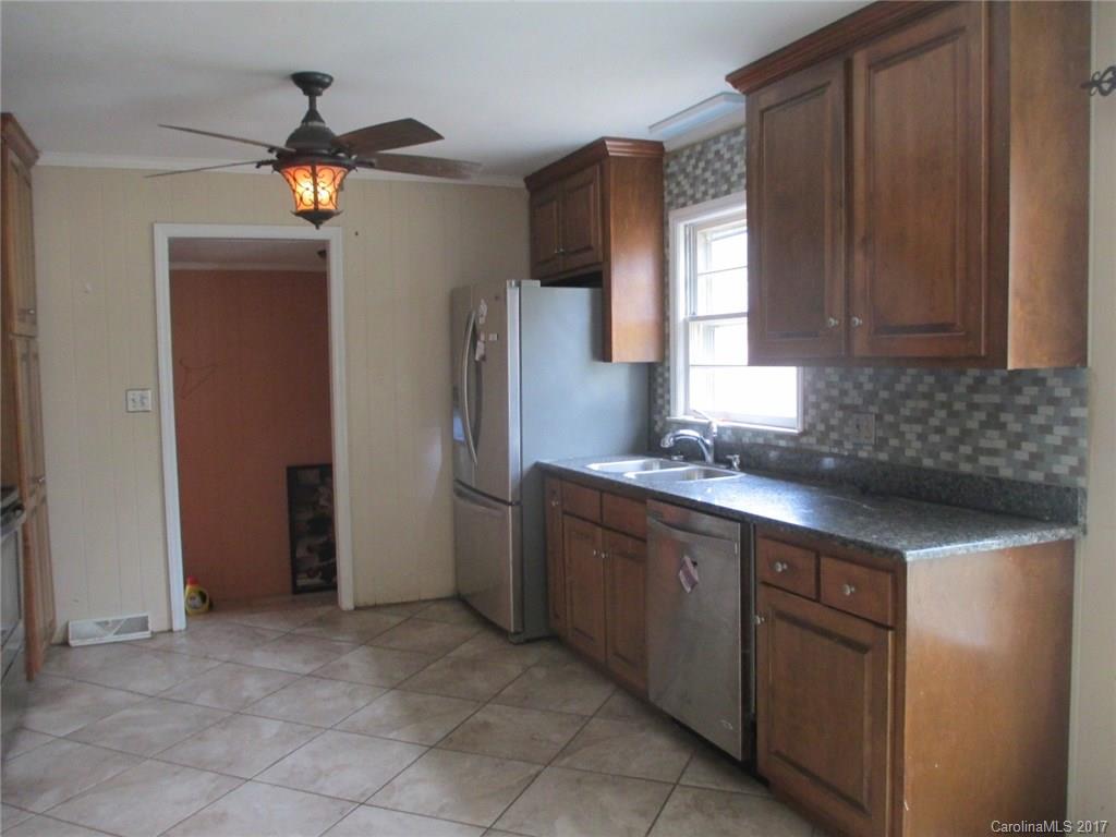 2312 Sunshine Road Lancaster, SC 29720 - Photo 12 of 16 a kitchen with stainless steel appliances granite countertop a refrigerator and a sink